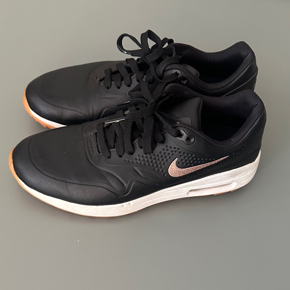 Nike Women's Black and White Sneakers with Gold Accents